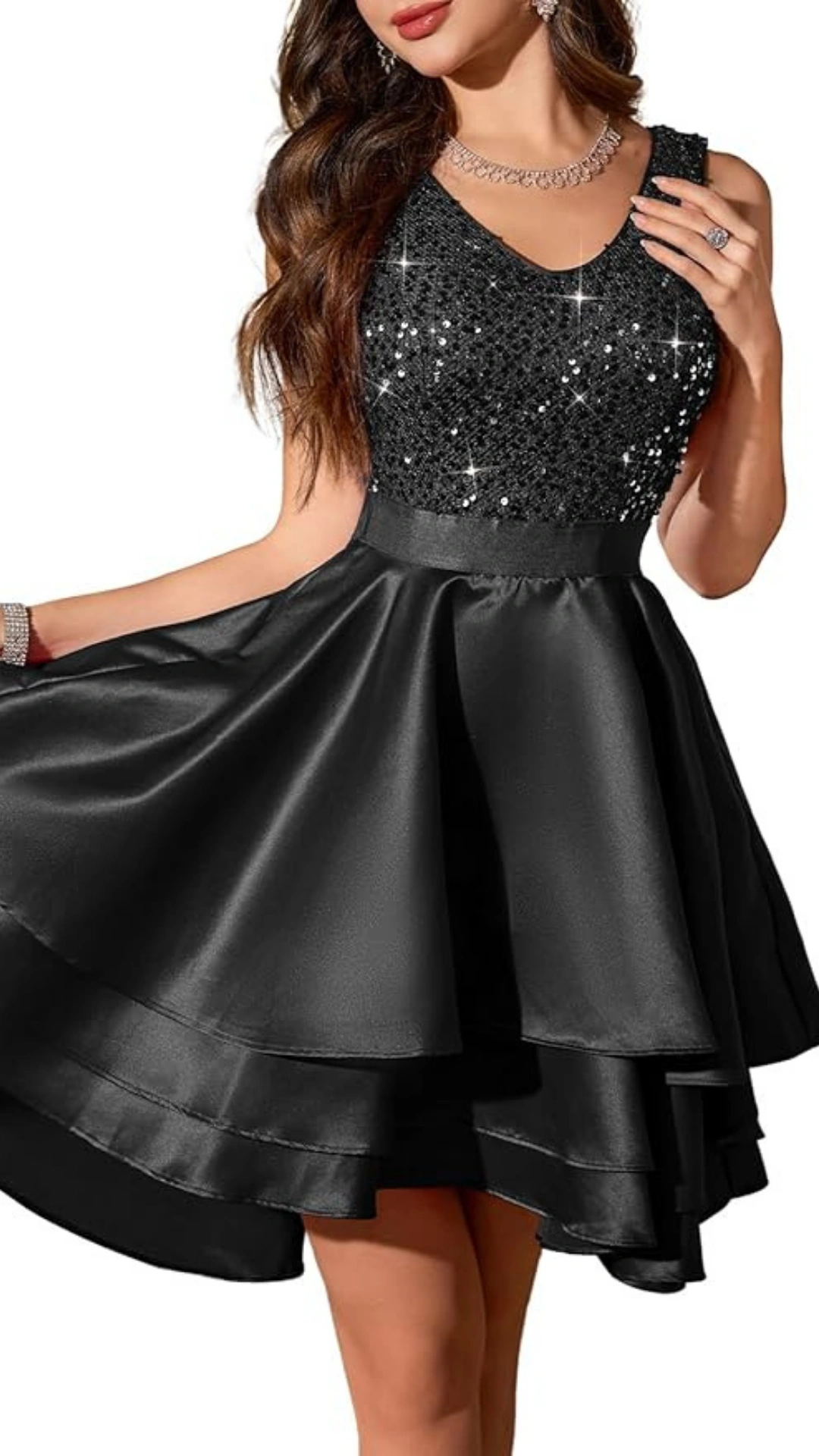 This black homecoming dress features a stunning sequined bodice that adds a touch of glamour, complemented by a satin, layered skirt that creates playful movement. The sleeveless design and fitted waist enhance the silhouette, making it perfect for teen girls attending formal events or school dances, offering a chic and sophisticated vibe.