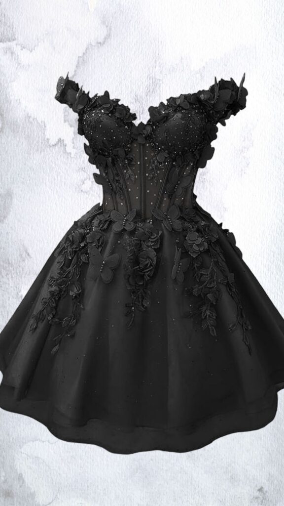 This elegant black mini dress features a fitted bodice adorned with intricate floral embellishments, rhinestones, and delicate mesh detailing, enhancing its feminine silhouette. The dress has an off-the-shoulder neckline and a flared, layered skirt that extends just above the knee, creating a playful hemline. The strategically placed cutouts and three-dimensional decorations add visual interest and texture, making it a striking choice for special occasions.