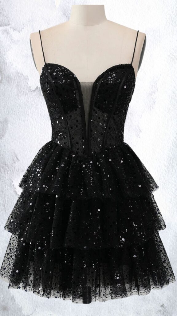 This black mini dress features a fitted bodice with a plunging neckline and thin spaghetti straps, creating an alluring silhouette. It is adorned with shimmering sequins and has a tiered, ruffled skirt that adds volume and movement, finishing at mid-thigh for a playful look. The dress balances elegance and fun with its combination of embellishments and flared hemline.