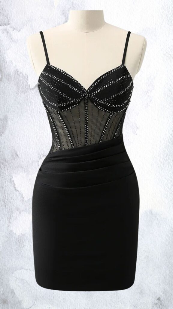 This black mini dress features a fitted silhouette with a sheer mesh top adorned with vertical rows of rhinestones that enhance its elegance. It has a sweetheart neckline, thin adjustable straps, and a draped waistline that transitions into a sleek, body-hugging skirt, creating a chic and sophisticated look perfect for evening events. The hemline falls mid-thigh, adding a touch of allure.