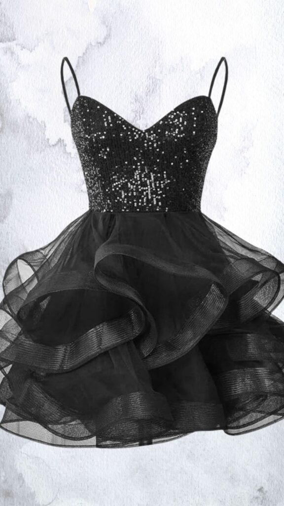 The dress features a fitted sweetheart neckline adorned with shimmering black sequins that catch the light. Flowing from the waist, the skirt is made of layered sheer tulle with ruffled hems, creating a playful, flared silhouette that ends mid-thigh. Thin adjustable straps provide support while enhancing the overall elegant and youthful look.
