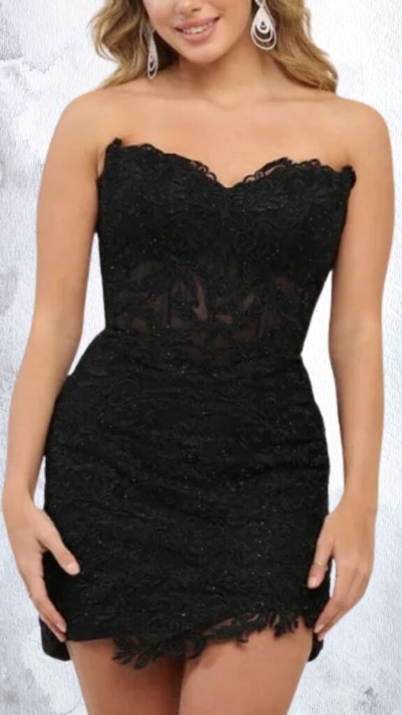 The dress features a fitted silhouette with a strapless, sweetheart neckline and a bodycon design that accentuates the waist. Its black fabric is richly embellished with textured detailing and shimmering beads, while the hemline is cut asymmetrically to create a playful yet elegant finish. The overall look combines sophistication with a hint of allure, ideal for evening wear.