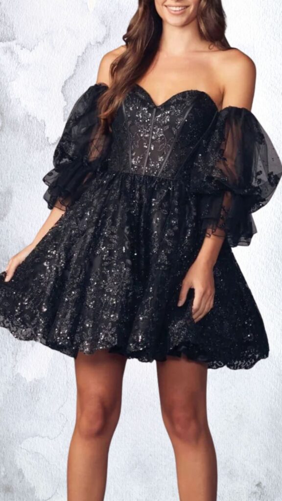 This black mini dress features a fitted bodice with a sweetheart neckline and intricate embellishments of beads and sequins, creating a sparkling effect. The dress has dramatic puff sleeves made of sheer mesh, with a flared skirt that adds volume, finishing above the knee with a scalloped hemline for an elegant touch.