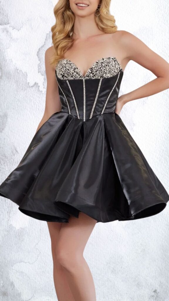 This black mini dress features a fitted bodice with a sweetheart neckline adorned with intricate bead and rhinestone embellishments. The skirt is flared, creating a playful silhouette, and is crafted from a glossy fabric that adds a touch of elegance, finishing above the knee with a flouncy hemline. The design highlights the waist with structured seams, enhancing the overall chic appeal.