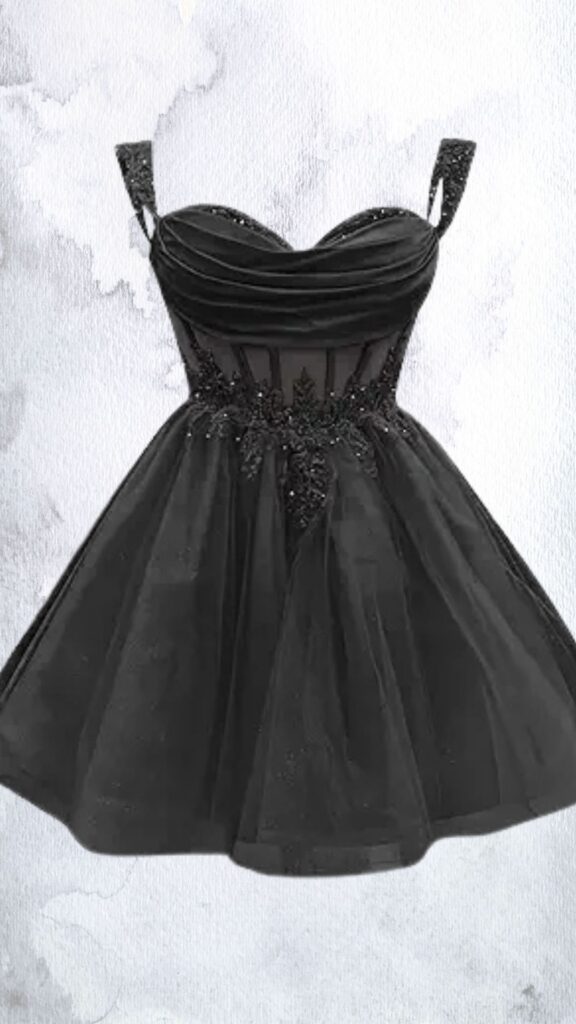 This black mini dress features a fitted, sweetheart neckline and delicate, embellished spaghetti straps. The bodice is adorned with intricate beadwork, while the skirt is made of flowing mesh that creates a playful, flared silhouette, finishing above the knee with a hem that adds elegance to the playful design.