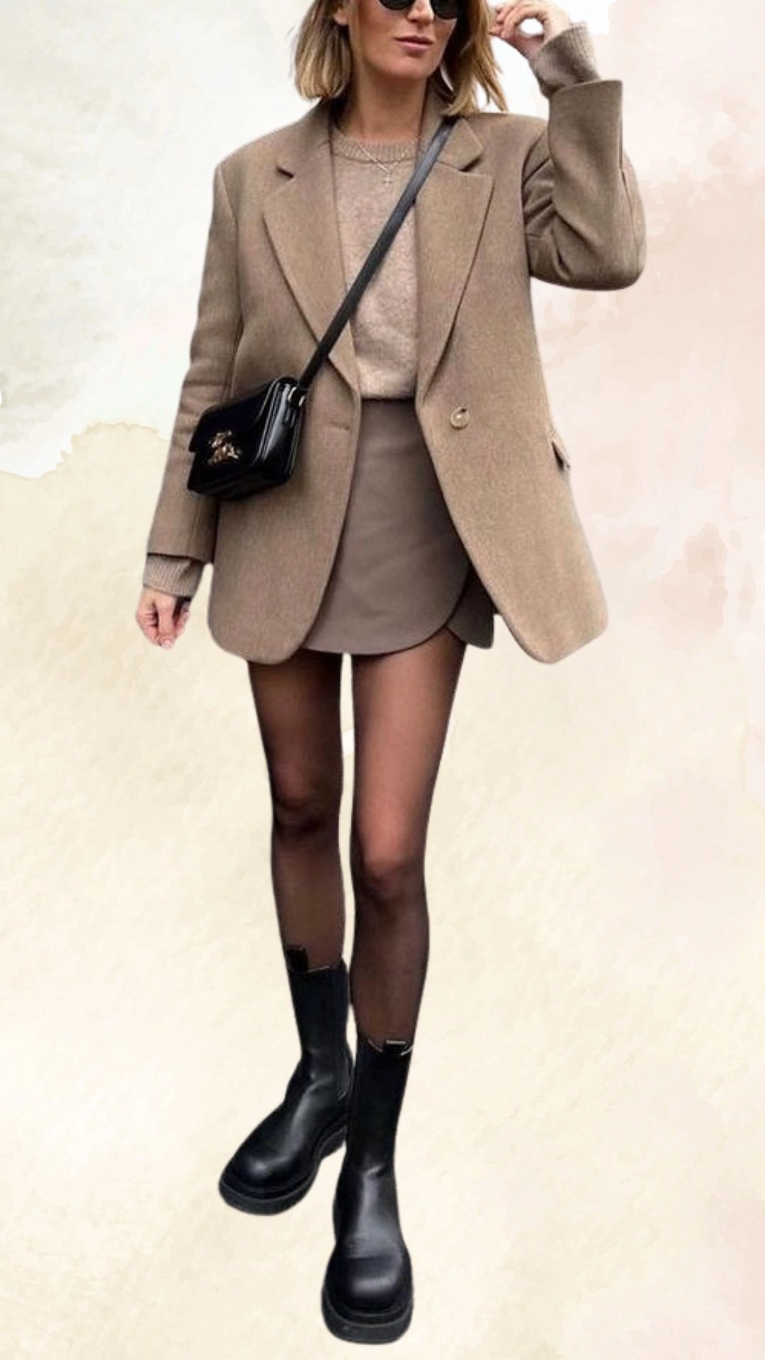 The outfit features a tailored beige blazer paired with a fitted light brown mini skirt, complemented by sheer black tights and black chunky ankle boots. The soft textures and neutral color palette create a cozy yet stylish look, perfect for casual fall outings. The overall fit is form-flattering with a structured silhouette while allowing for comfortable movement.