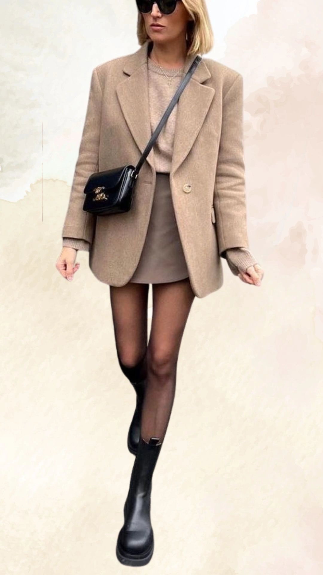 The outfit features a tailored beige oversized blazer paired with a fitted beige sweater underneath and a sleek beige mini skirt, creating a cohesive monochromatic look. The model wears knee-high black boots, adding a modern edge, while sheer black tights complement the overall fall aesthetic. This ensemble showcases a relaxed yet polished fit, perfect for casual autumn outings.