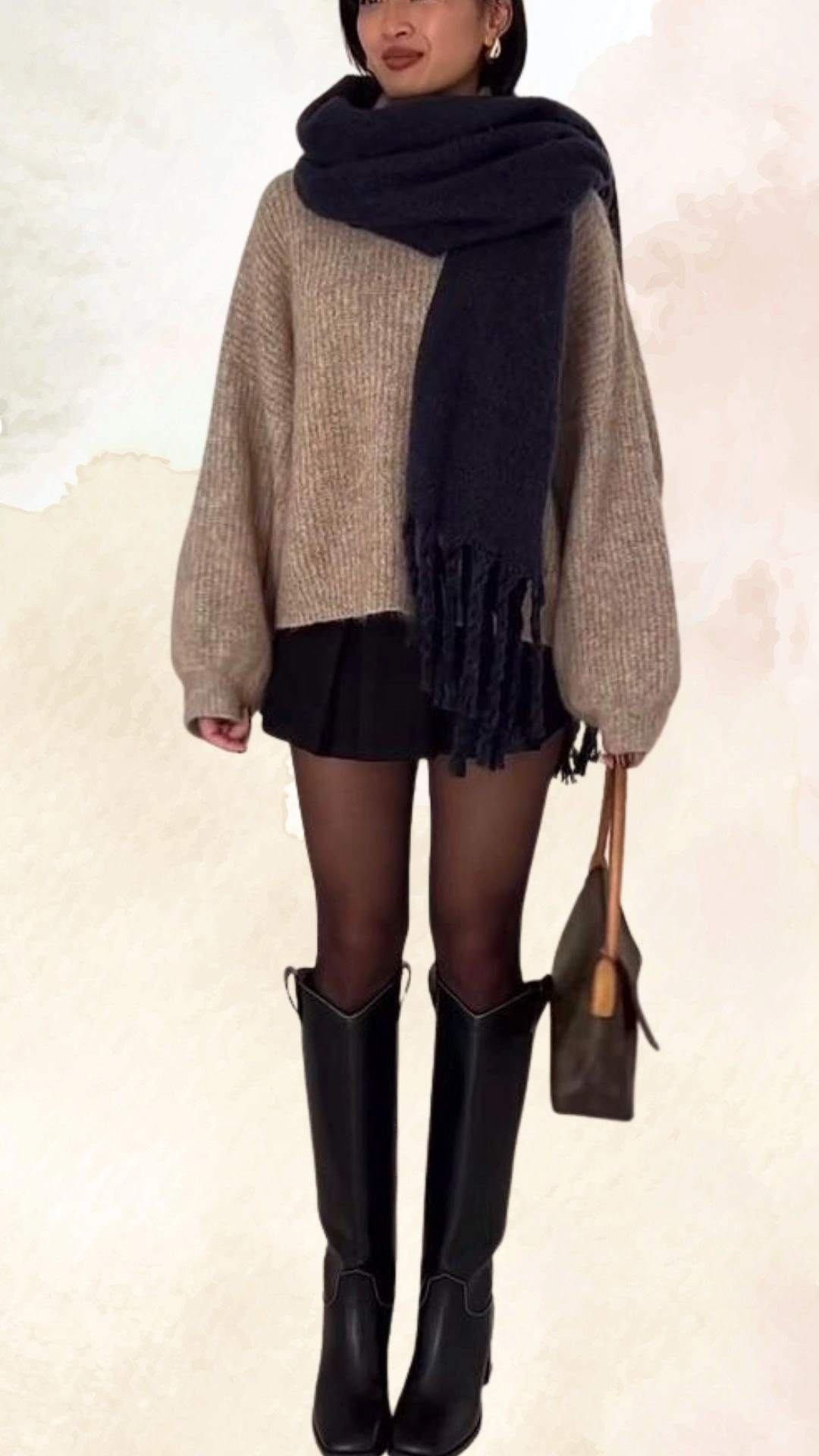 The outfit features a cozy, oversized beige knit sweater with voluminous sleeves paired with a sleek black mini skirt. Accessories include a chunky navy scarf draped around the neck, black knee-high fitted boots, and a brown handbag, creating a warm and stylish ensemble perfect for casual fall outings. The sweater's relaxed fit contrasts with the skirt’s snug silhouette, offering a balanced look.