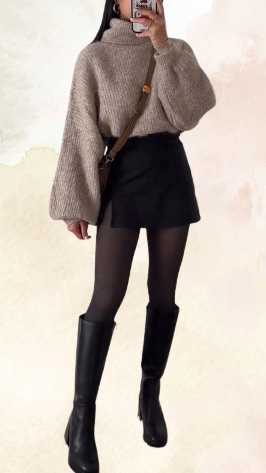 The outfit features a soft, oversized beige turtleneck sweater with a textured knit design, paired with a black mini skirt that has a subtle slit detail. The look is completed with sheer black tights and knee-high black leather boots, creating a chic and cozy fall ensemble. The relaxed fit of the sweater contrasts with the fitted silhouette of the skirt, offering a balanced and stylish appearance.