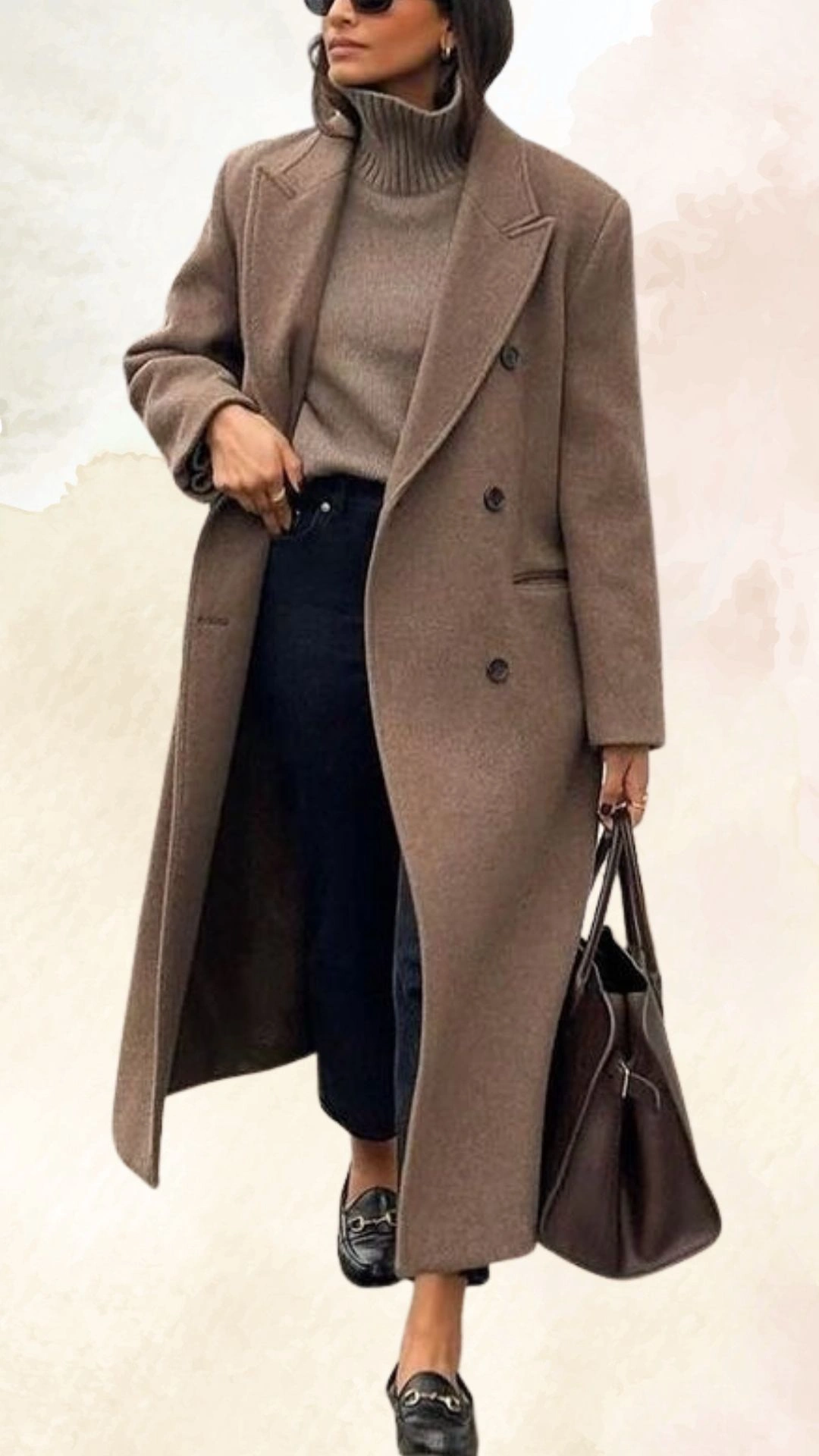The outfit features a cozy, taupe turtleneck sweater paired with high-waisted, dark denim jeans, creating a sleek silhouette. A long, oversized brown coat with a double-breasted design adds warmth and sophistication, while black loafers complete the look with a touch of elegance. The overall fit is relaxed yet chic, making it perfect for casual fall outings.