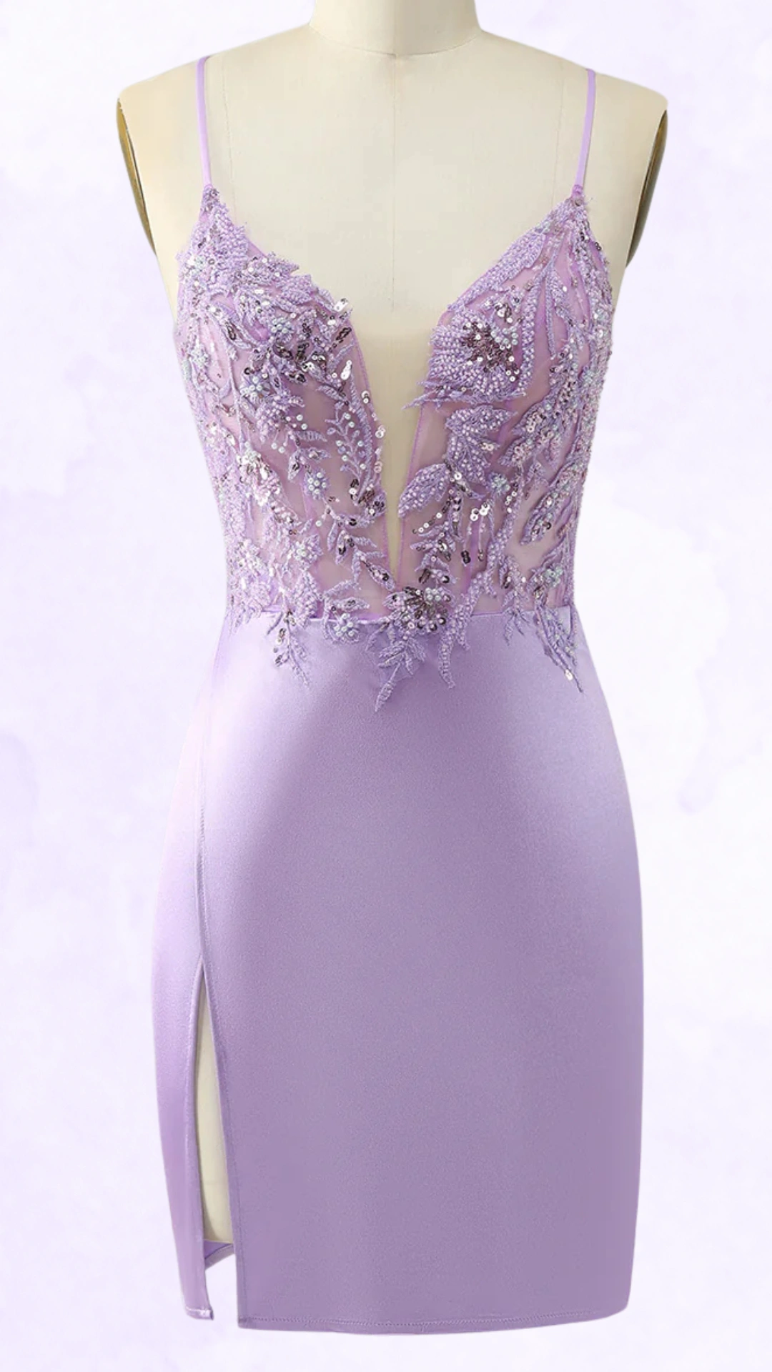 This fitted homecoming dress features a shimmering lavender hue, complemented by intricate beaded embroidery across the sheer bodice, showcasing a plunging neckline and adjustable spaghetti straps. The smooth, stretchy fabric hugs the body with a side slit for added allure, making it perfect for a chic party or school dance, radiating a trendy and elegant vibe ideal for teenage girls.