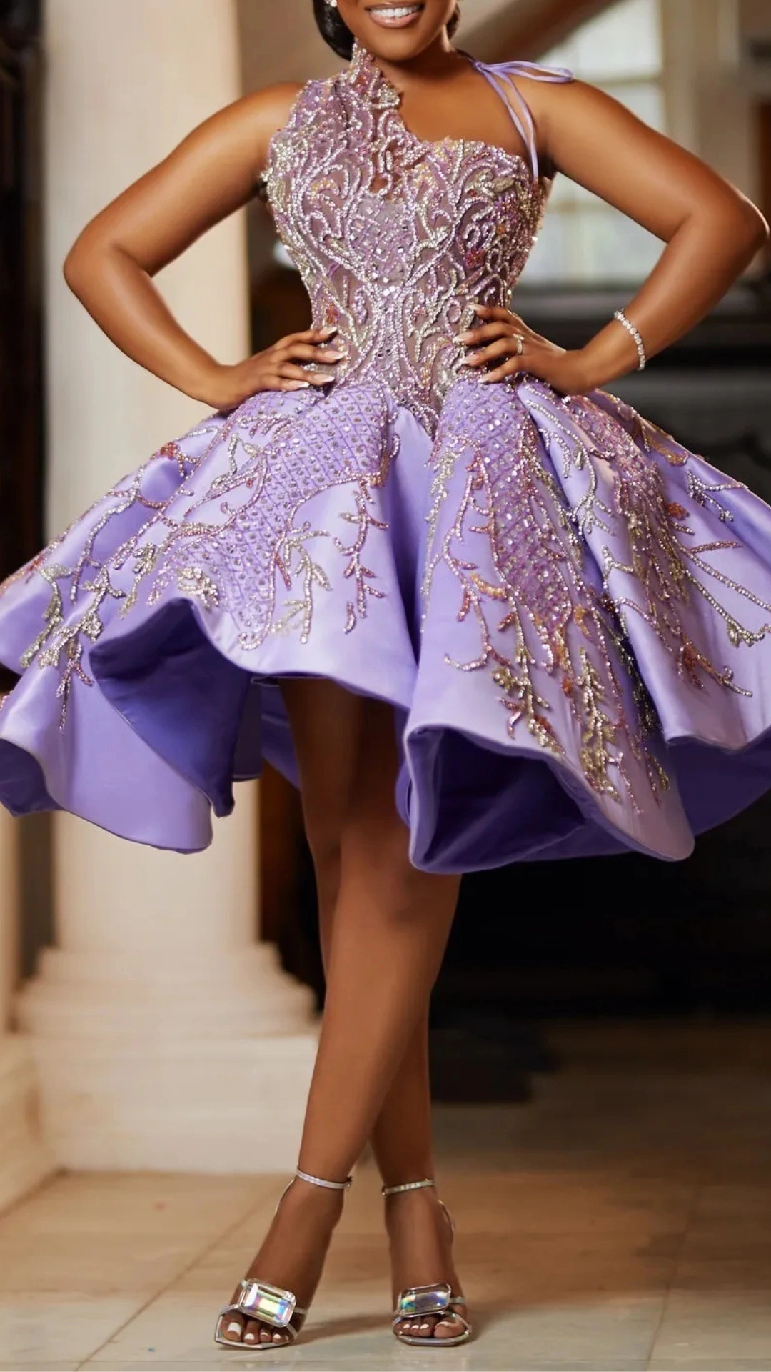 This homecoming dress features a fitted bodice adorned with intricate beadwork and floral patterns, transitioning into a voluminous skirt that adds a playful flair. The soft lavender hue enhances its romantic vibe, making it an ideal choice for teens attending formal events or school dances.