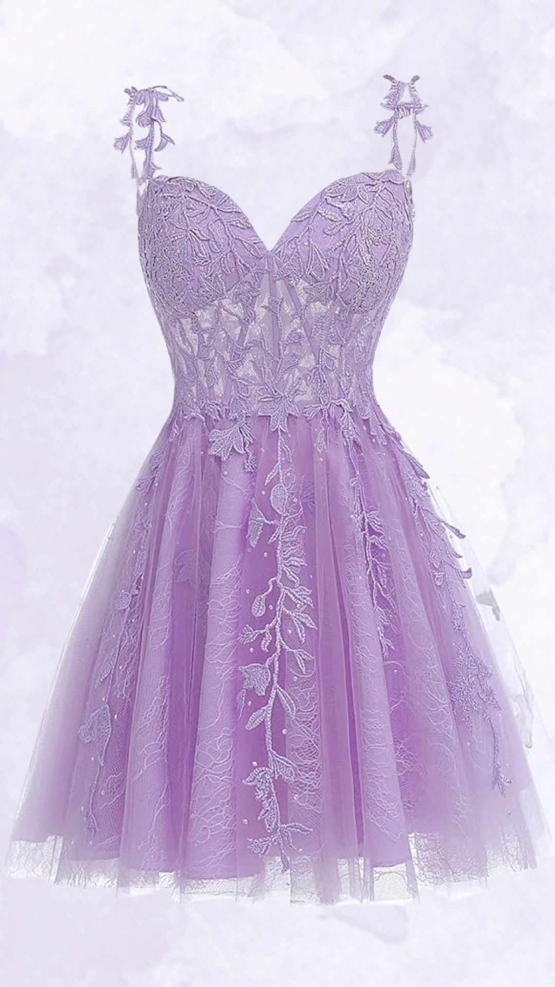 This captivating homecoming dress features a delicate lavender hue with intricate floral lace embroidery, creating a charming and ethereal aesthetic. The fitted bodice leads to a voluminous tulle skirt, making it a perfect choice for teen girls at formal events or school dances, embodying a romantic and whimsical vibe.