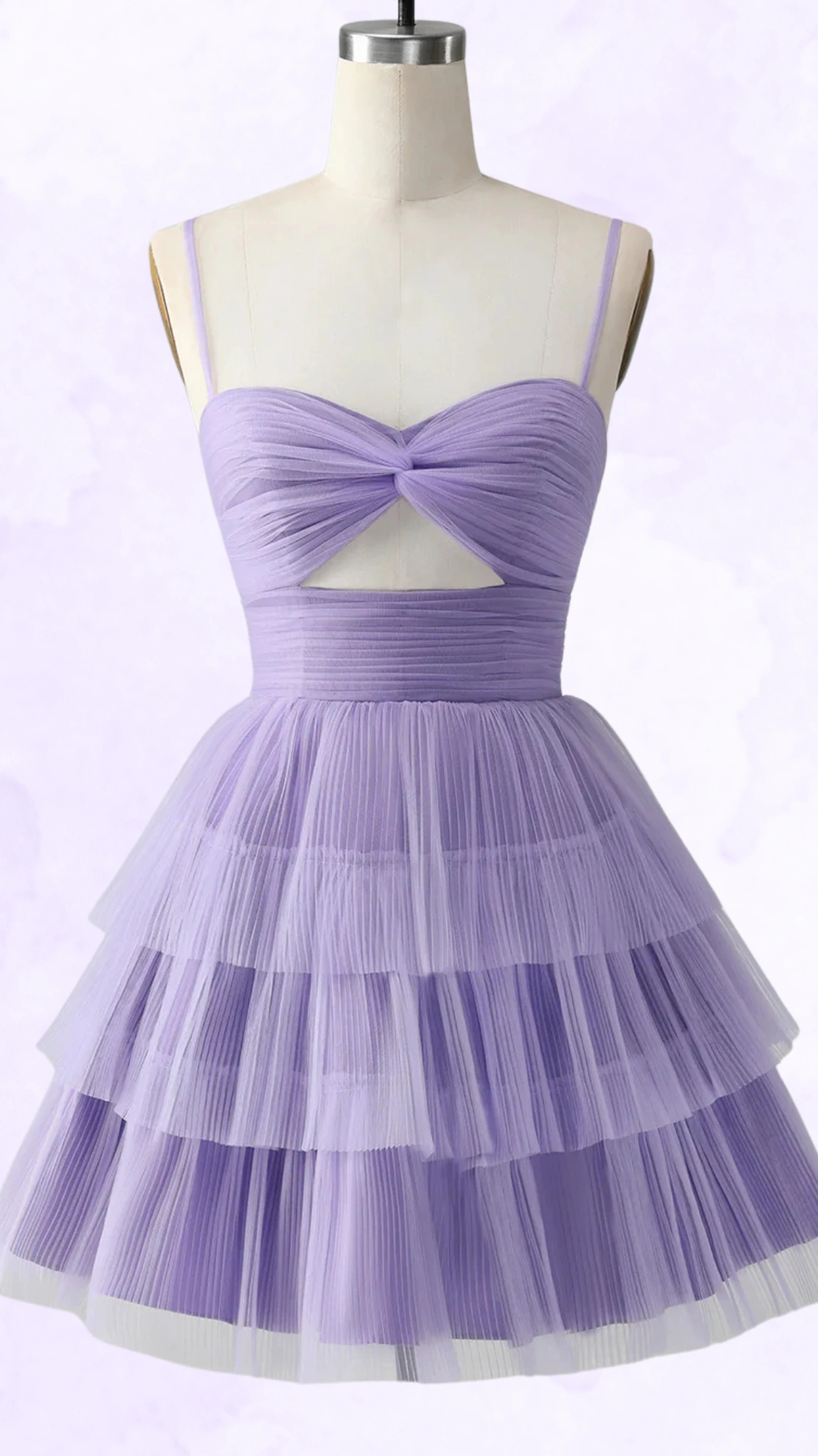 This playful homecoming dress features a lavender color with a soft, layered tulle skirt that creates an enchanting, voluminous effect. The fitted bodice is adorned with pleated details and a twist design that showcases a subtle cutout, making it a chic choice for teenage girls attending formal events or dances.