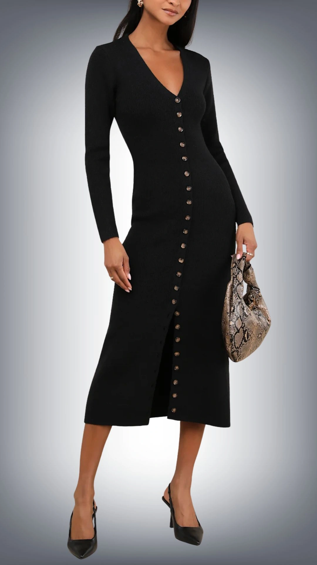 The sweater dress features a sleek, form-fitting silhouette that hits mid-calf, crafted from a soft, textured black knit. It has long sleeves, a deep V-neckline, and a stylish row of round buttons running down the front, which adds a subtle detail, enhancing the overall elegant look. The fit gently hugs the body, accentuating curves while offering comfort and warmth.