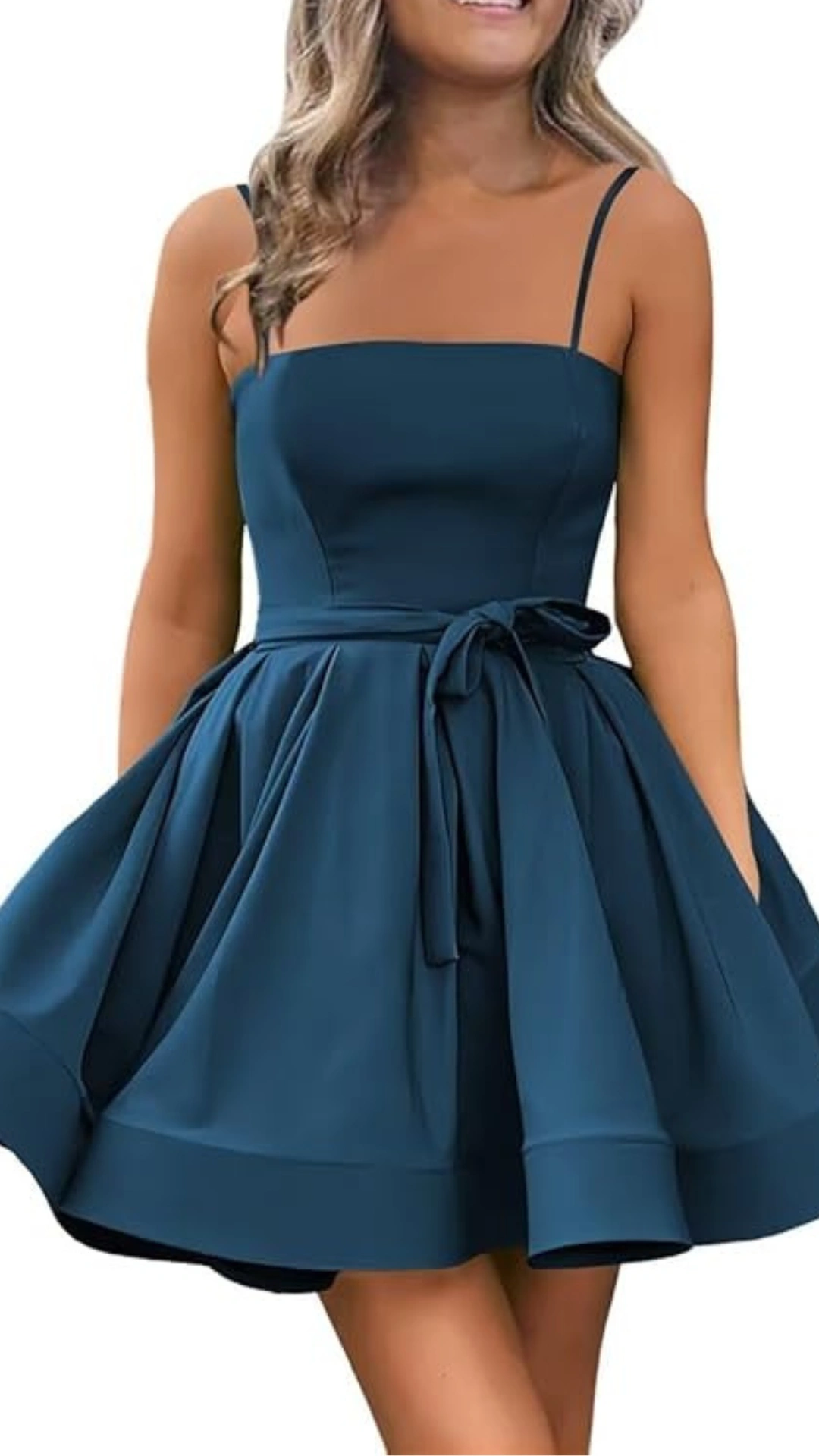 This charming homecoming dress features a structured bodice with thin spaghetti straps and a playful, voluminous skirt, crafted from a smooth, lightweight fabric in a deep teal color. The fitted waist is accentuated by a matching tie belt, creating a flirty yet elegant look perfect for teens attending formal events or school dances.