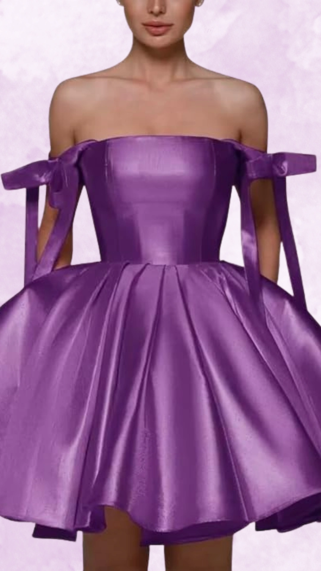 This strapless, vibrant purple homecoming dress features a structured bodice and playful, voluminous skirt, crafted from smooth satin that adds a luxurious sheen. The delicate bow accents on the shoulders enhance its youthful, whimsical vibe, making it an ideal choice for a fun, celebratory occasion for teenage girls.